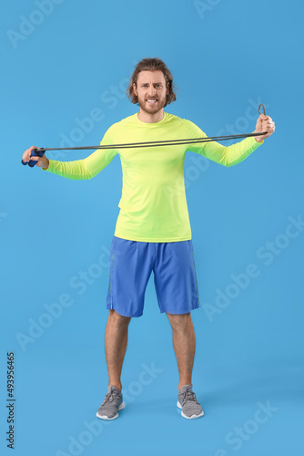Sporty man with jumping rop...
