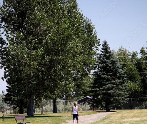Mature female senior on walking trail outdoors.