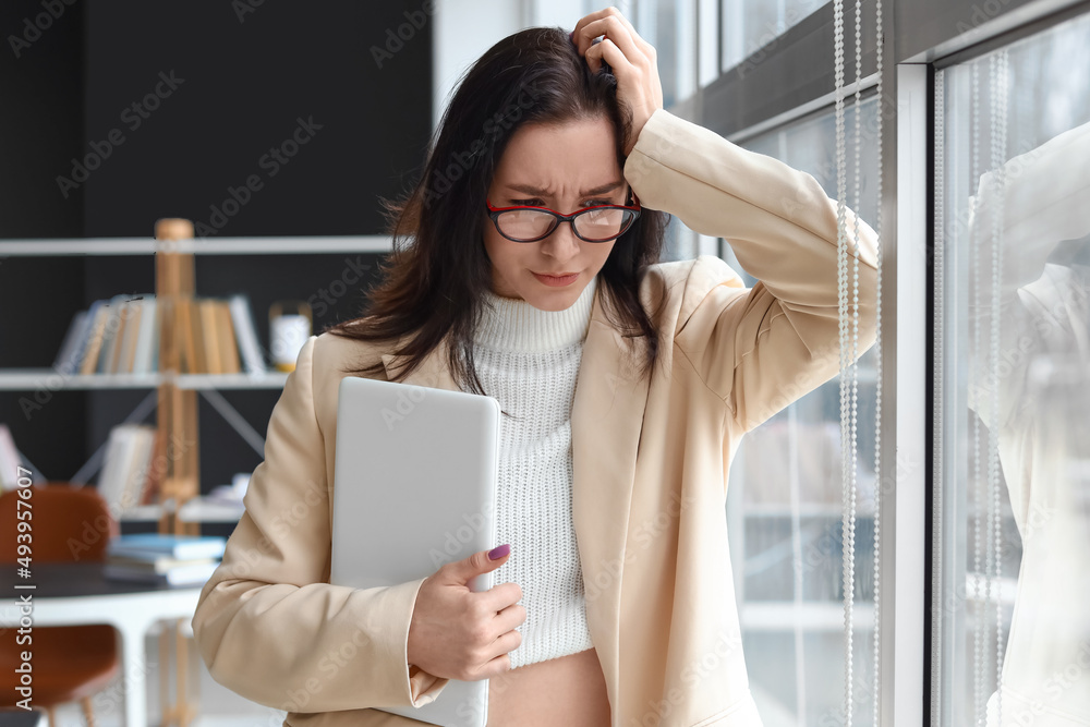 Worried young businesswoman near window in office Worried young businesswoman near window in office