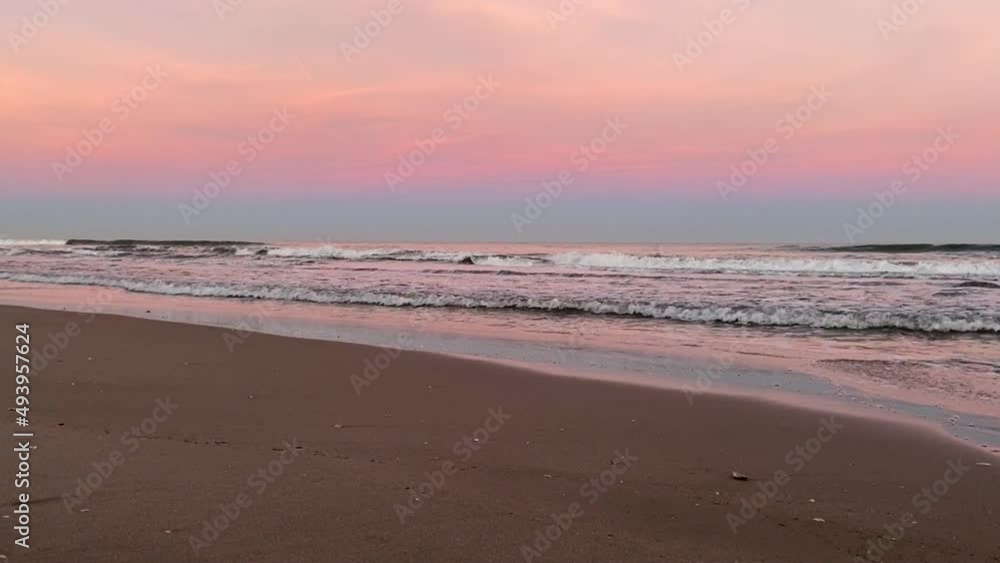Waves at sea on dramatic sunset background. Waves at sea during storm and wind. Wave from the sea goes on land to the beach. Splashing Waves in ocean, background, texture. Wave at Rising Storm.