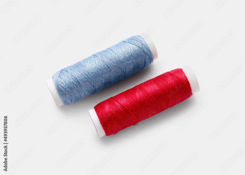 Different thread spools on white background Different thread spools on white background