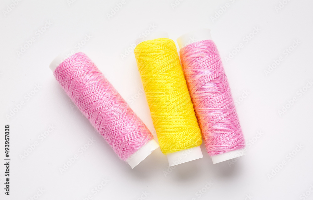 Different thread spools on white background Different thread spools on white background