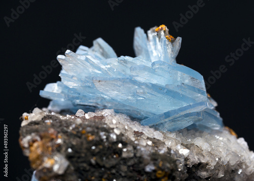 Close-up shot of barite stone mineral specimen isolated on a black background photo