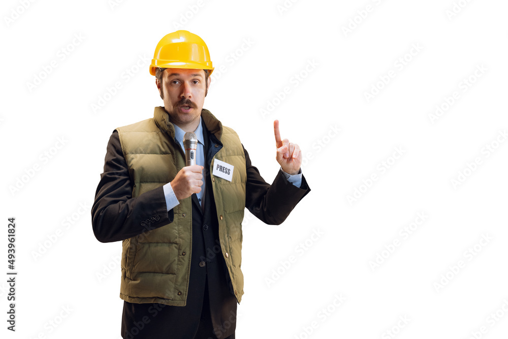Portrait of young man in helmet, professional commentator, journalist with microphone broadcasting isolated over white background. News, emotions, job concept Portrait of young man in helmet, professional commentator, journalist with microphone broadcasting isolated over white background. News, emotions, job concept