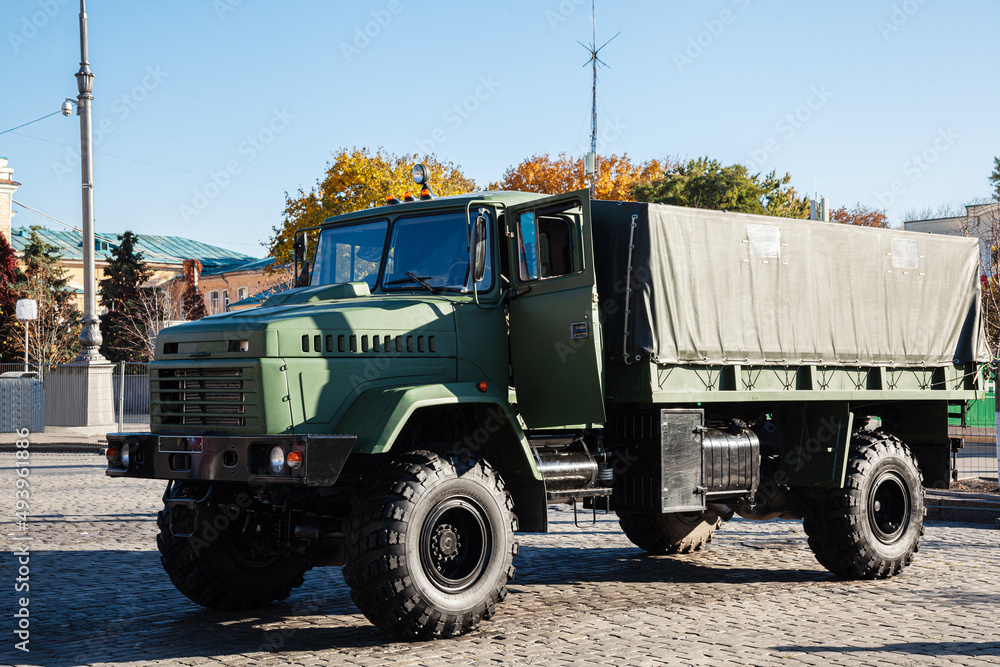 A military truck in a khaki protective camouflage that provides transportation of goods and military soldiers, a universal military transport. Ukrainian Army vehicle