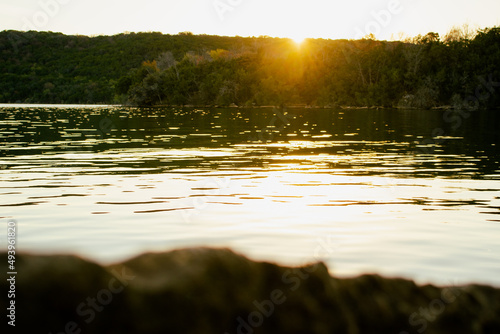 Fototapeta Naklejka Na Ścianę i Meble -  Scenic view of the Possum Kingdom lake reflecting the sun rays with green lush forests in background