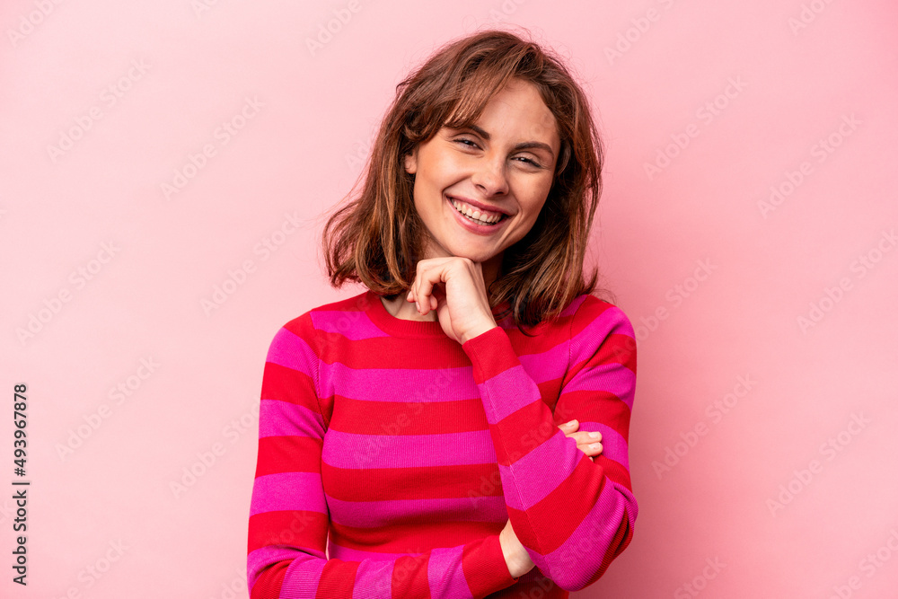 Young caucasian woman isolated on pink background smiling happy and confident, touching chin with hand. Young caucasian woman isolated on pink background smiling happy and confident, touching chin with hand.
