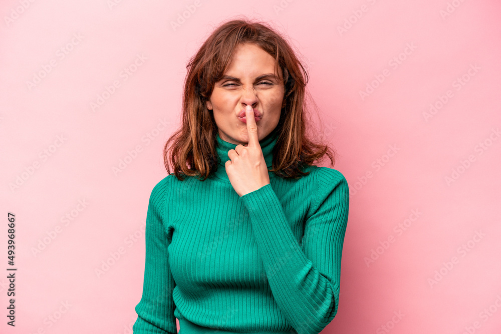 Young caucasian woman isolated on pink background thinking and looking up, being reflective, contemplating, having a fantasy. Young caucasian woman isolated on pink background thinking and looking up, being reflective, contemplating, having a fantasy.