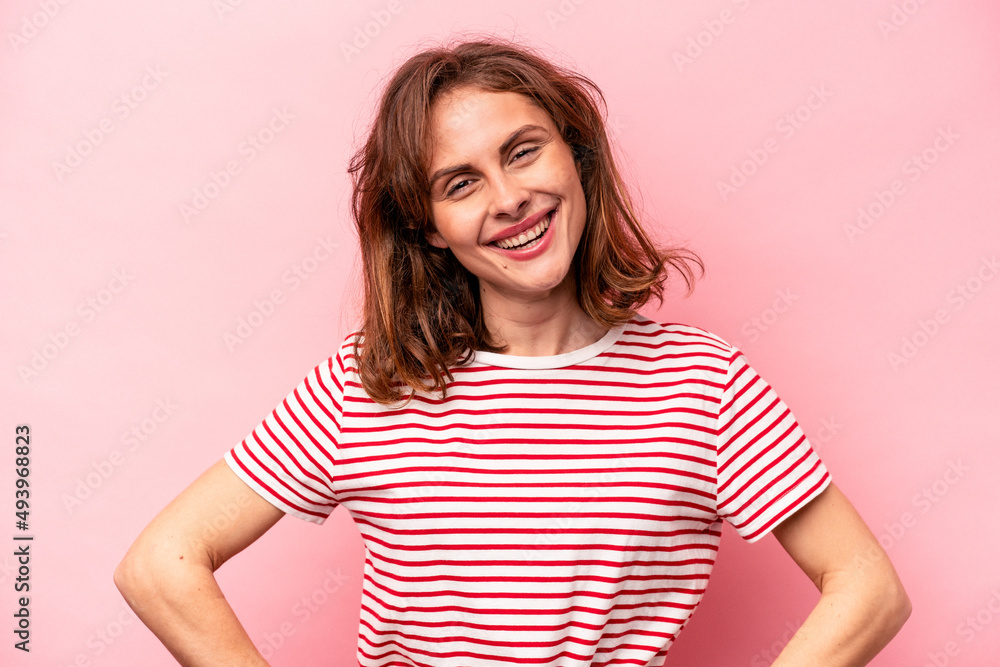 Young caucasian woman isolated on pink background happy, smiling and cheerful. Young caucasian woman isolated on pink background happy, smiling and cheerful.