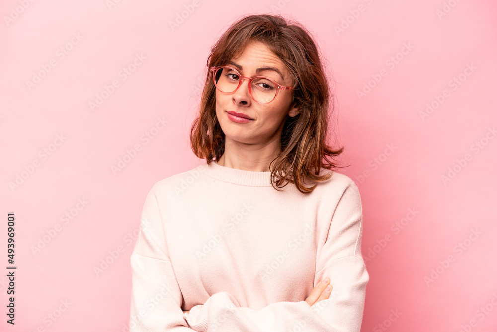 Fototapeta premium Young caucasian woman isolated on pink background unhappy looking in camera with sarcastic expression.