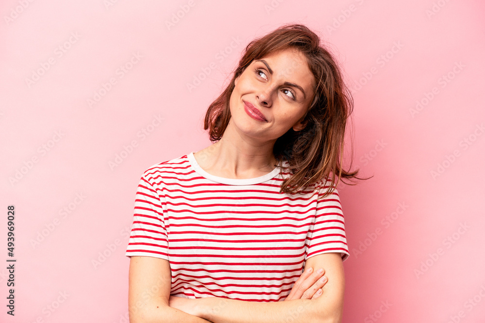 Young caucasian woman isolated on pink background dreaming of achieving goals and purposes Young caucasian woman isolated on pink background dreaming of achieving goals and purposes