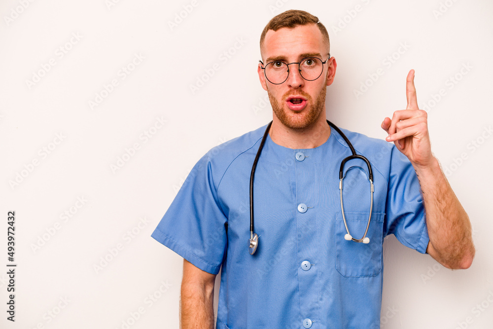 Young caucasian nurse man isolated on white background showing number one with finger. Young caucasian nurse man isolated on white background showing number one with finger.