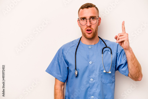 Young caucasian nurse man isolated on white background showing number one with finger.