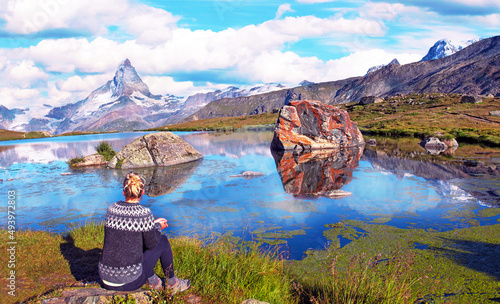 Obraz na płótnie Scenic landscape in the Swiss Alps with a girl who looks at the top of the mountain Matterhorn near the Lake Stelliseenear Zermatt. w salonie