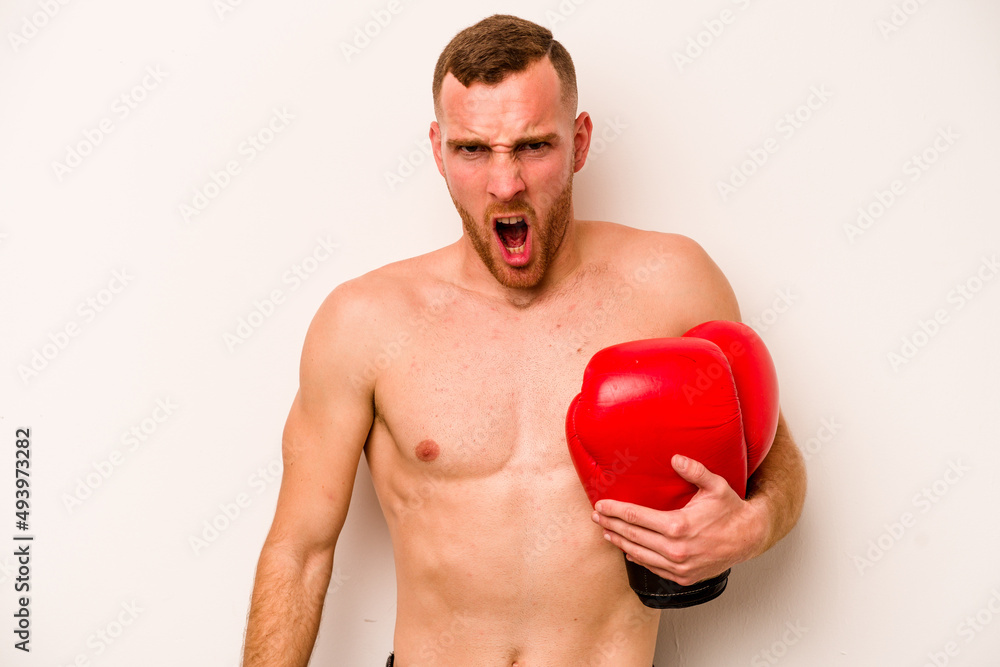 Young caucasian man doing boxing isolated on white background screaming very angry and aggressive. Young caucasian man doing boxing isolated on white background screaming very angry and aggressive.