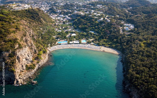 Sandy beach in a bay surrounded by hills (aerial drone photo). Ischia island, Italy photo