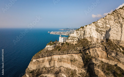 White lighthouse on a seaside cliff (aerial drone photo). Mediterranean, Ischia island, Italy