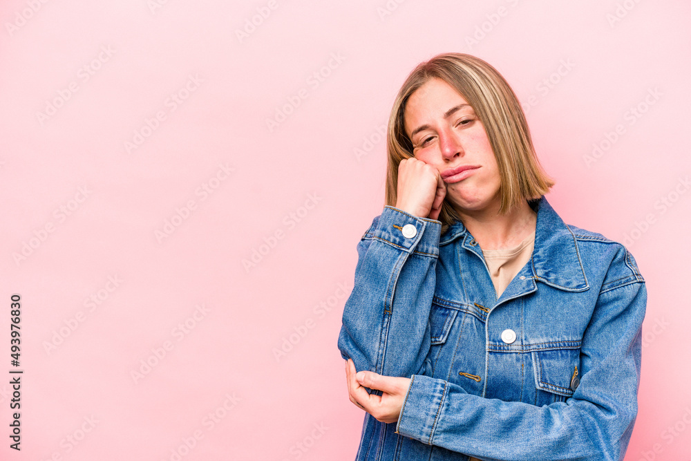 Young caucasian woman isolated on pink background who feels sad and pensive, looking at copy space. Young caucasian woman isolated on pink background who feels sad and pensive, looking at copy space.