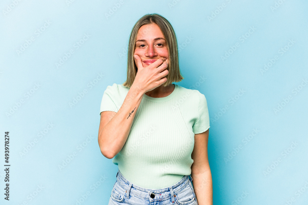 Young caucasian woman isolated on blue background doubting between two options. Young caucasian woman isolated on blue background doubting between two options.