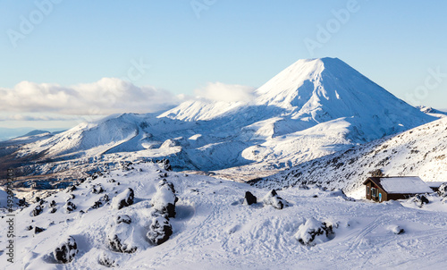 Scenic view of the mount Ngauruhoe covered with snow under the clear sky photo