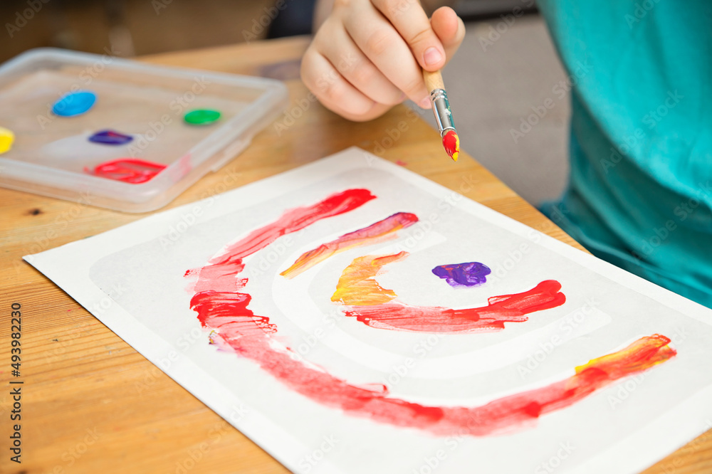 A different rainbow. Boys drawing with gouache. Children activities for raining day. A different rainbow. Boys drawing with gouache. Children activities for raining day.