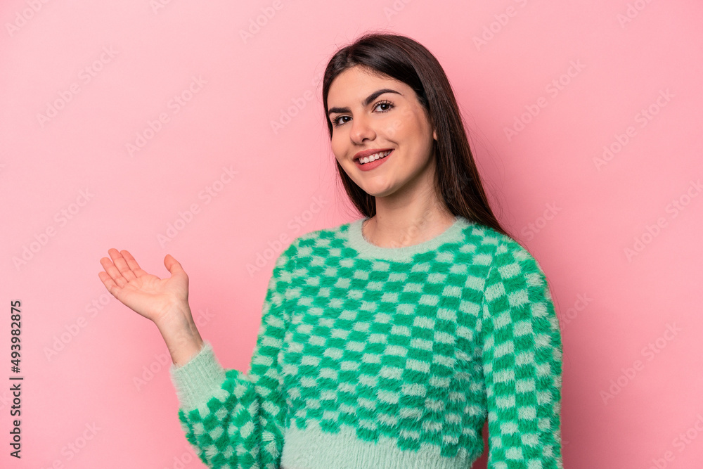 Young caucasian woman isolated on pink background showing a welcome expression. Young caucasian woman isolated on pink background showing a welcome expression.