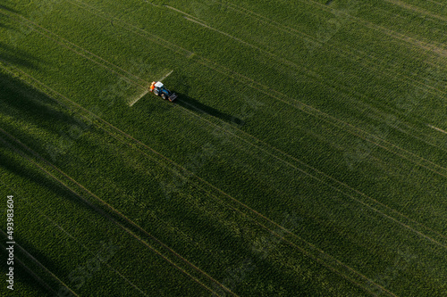 Billede på lærred Aerial view of tractor spraying pesticides at agriculture field
