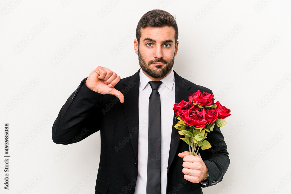 Young caucasian man holding a bouquet of flowers isolated on white background showing a dislike gesture, thumbs down. Disagreement concept. Young caucasian man holding a bouquet of flowers isolated on white background showing a dislike gesture, thumbs down. Disagreement concept.