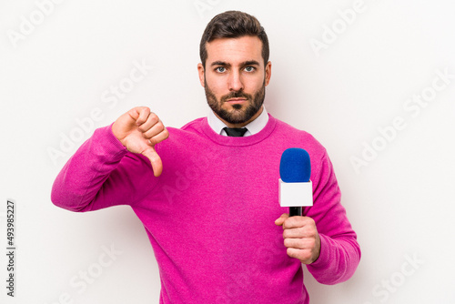 Young caucasian tv presenter man isolated on white background showing a dislike gesture, thumbs down. Disagreement concept.