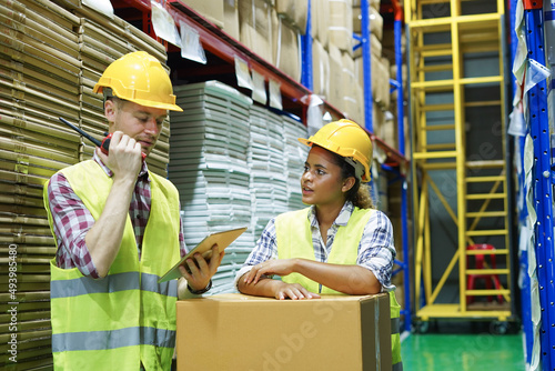 Worker inventory inspect staff checking cardboard package box and communicate with team in warehouse factory storage products shipment distributor logistic supply for counting and management