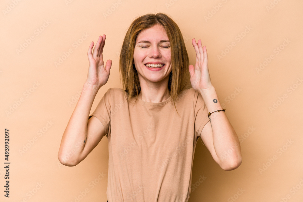 Young English woman isolated on beige background joyful laughing a lot. Happiness concept. Young English woman isolated on beige background joyful laughing a lot. Happiness concept.