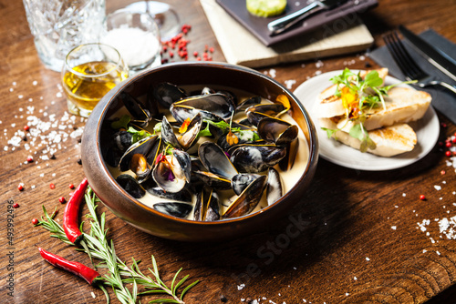 Blue mussels in cream wine sauce. Delicious healthy Italian traditional food closeup served for lunch in modern gourmet cuisine restaurant