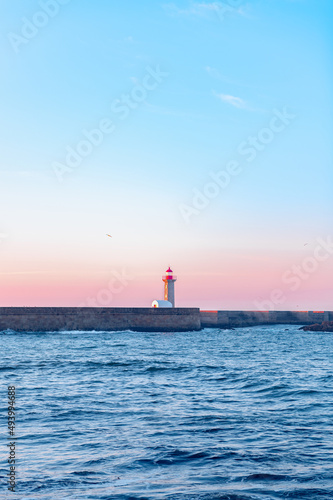 Farolim de Felgueiras is 19th century hexagonal lighthouse on the Douro River, Porto, Portugal during sunrise