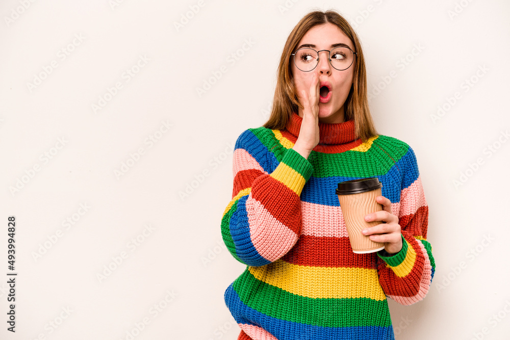 Young caucasian woman holding a take away coffee isolated on white background is saying a secret hot braking news and looking aside Young caucasian woman holding a take away coffee isolated on white background is saying a secret hot braking news and looking aside