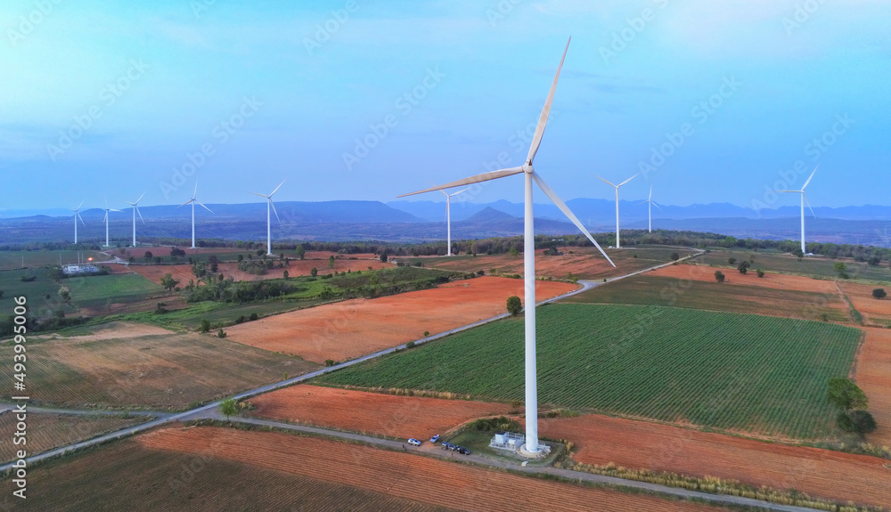 Aerial view wind turbine will farms in rotation to generate electricity energy on outdoor. Green ecological power energy generation wind farm eco field is sustainable energy concept.