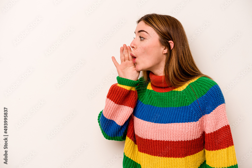 Young caucasian woman isolated on white background is saying a secret hot braking news and looking aside Young caucasian woman isolated on white background is saying a secret hot braking news and looking aside