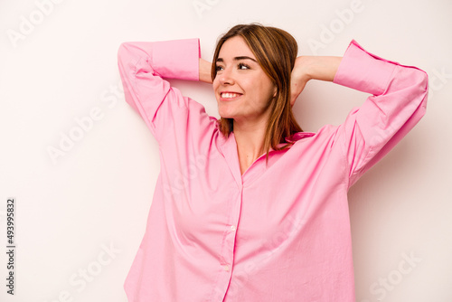 Young caucasian woman isolated on white background feeling confident, with hands behind the head.