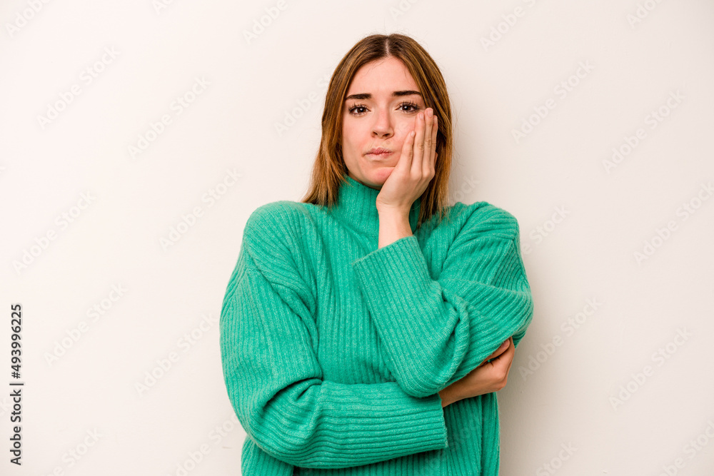 Young caucasian woman isolated on white background blows cheeks, has tired expression. Facial expression concept. Young caucasian woman isolated on white background blows cheeks, has tired expression. Facial expression concept.