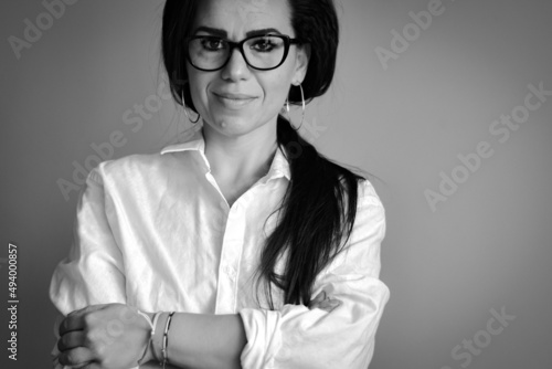  Studio Black and white Portrait of Beautiful smiling Business Woman .Young attractive woman presenting business strategy for cryptocurrency company 