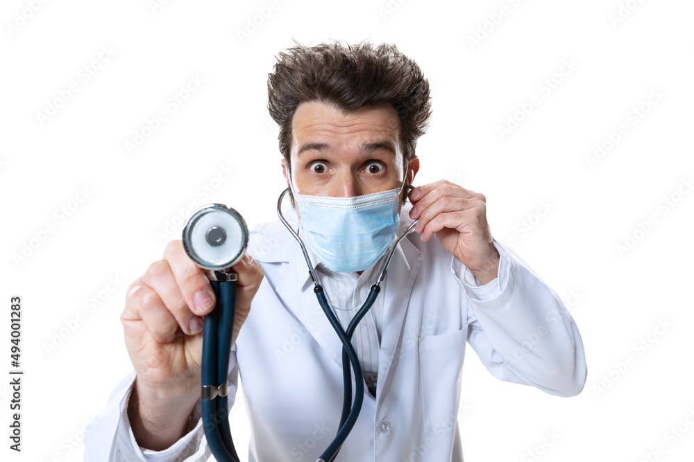Male young doctor with stethoscope and face mask on white studio background. Concept of healthcare and medicine, war, help, treatment Male young doctor with stethoscope and face mask on white studio background. Concept of healthcare and medicine, war, help, treatment
