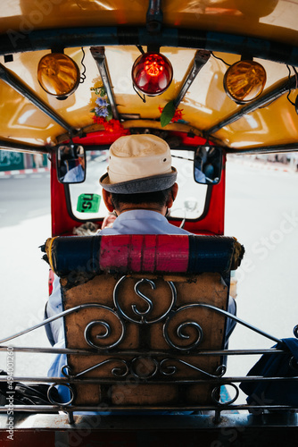 Canvas Print Vertical shot of a person driving a colorful taxi in Bangkok, Thailand