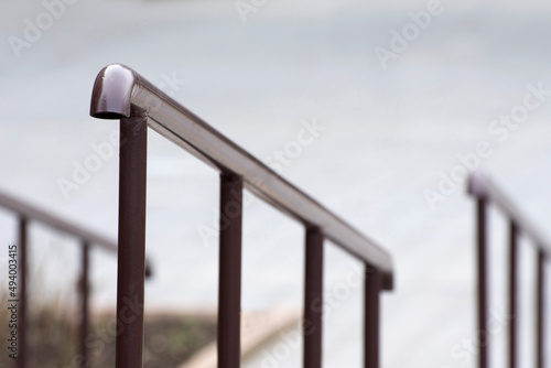 Iron railing of a staircase. Ramp for people with disabilities