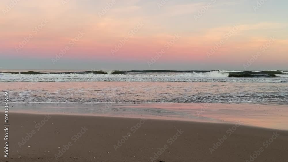 Waves at sea on dramatic sunset background. Waves at sea during storm and wind. Wave from the sea goes on land to the beach. Splashing Waves in ocean, background, texture. Wave at Rising Storm. Waves at sea on dramatic sunset background. Waves at sea during storm and wind. Wave from the sea goes on land to the beach. Splashing Waves in ocean, background, texture. Wave at Rising Storm.