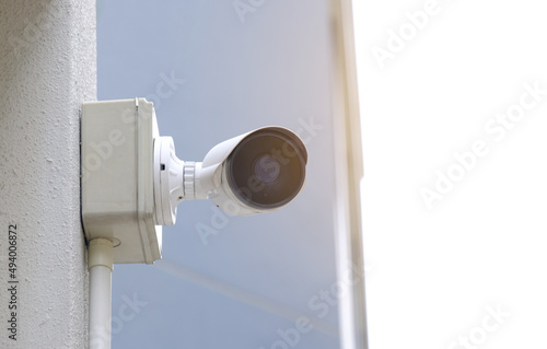 Modern public CCTV camera on blur building background. Recording cameras for monitoring all day and night. Concept of surveillance and monitoring with copy space.