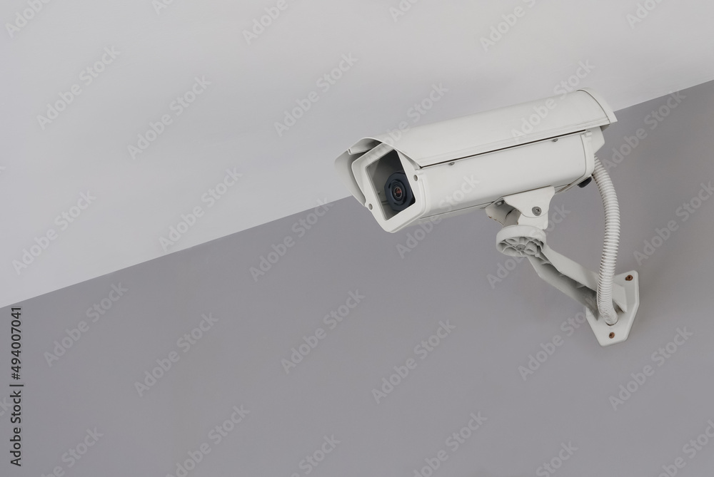 Modern public CCTV camera on cement wall inside the building. Recording cameras for monitoring all day and night. Concept of surveillance and monitoring with copy space. Modern public CCTV camera on cement wall inside the building. Recording cameras for monitoring all day and night. Concept of surveillance and monitoring with copy space.