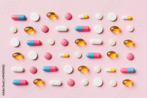 Many different pills and space for text on colorful background, top view. Different pills on color background, flat lay