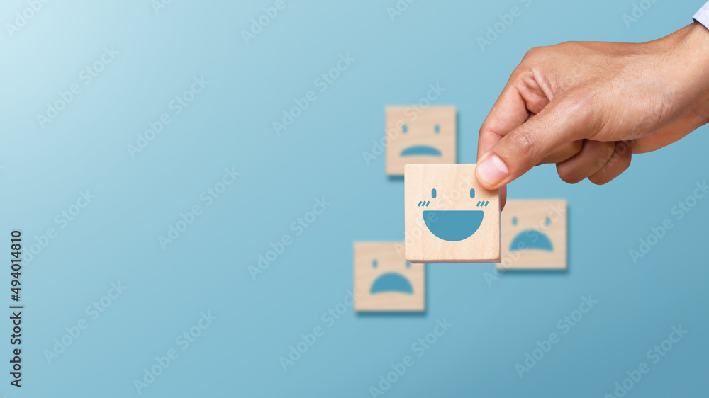 Hand of client show a feedback with smile face. Service rating, satisfaction concept Hand of client show a feedback with smile face. Service rating, satisfaction concept