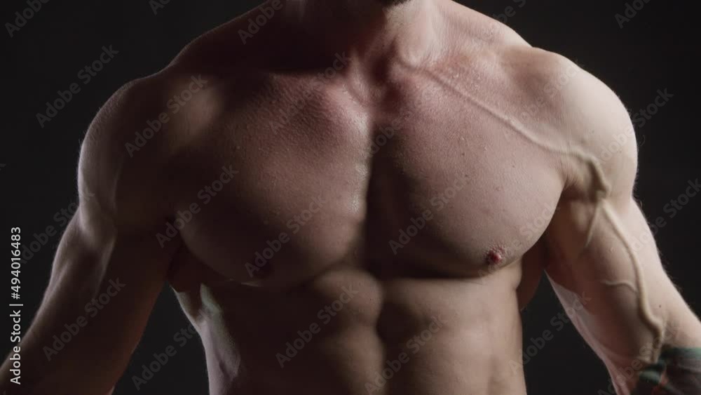 Athletic man tensing his pectoral muscles Athletic man tensing his pectoral muscles