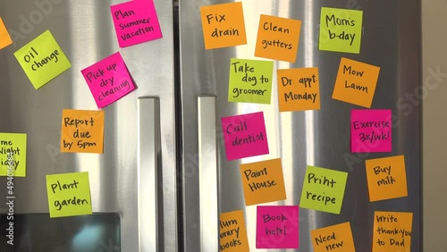 Refrigerator Door Full of Reminder Notes Hand Adds File Taxes Memo