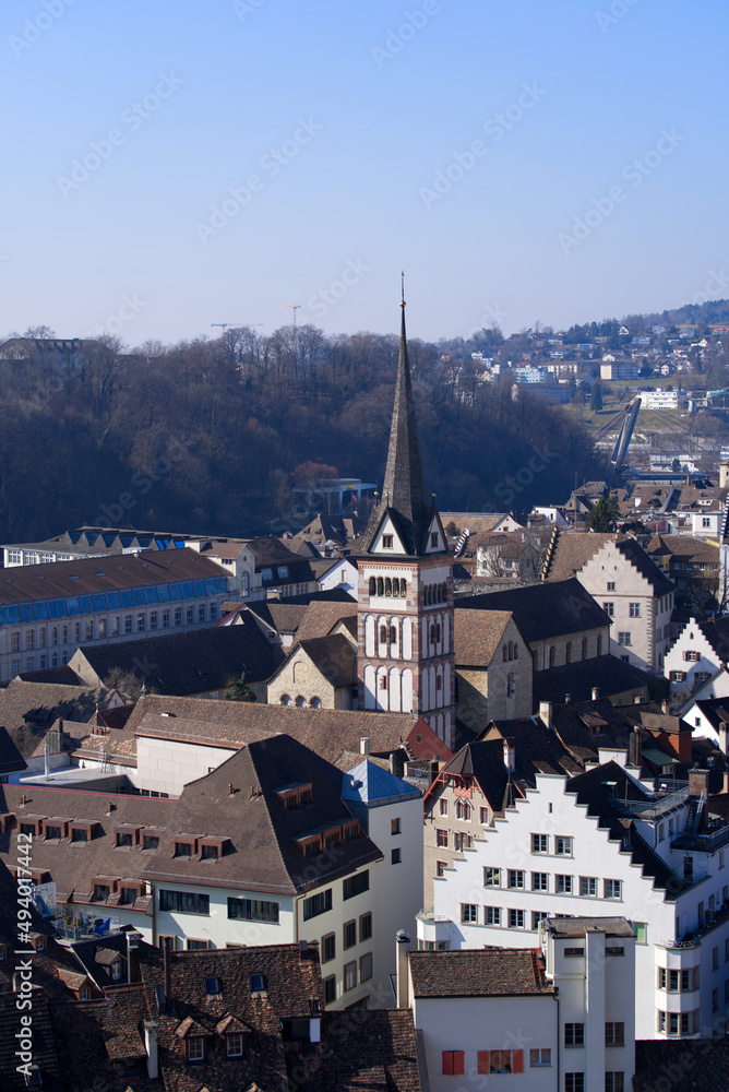 Aerial view over City of Schaffhausen with Minster Church seen from historic fortification named Munot on a sunny spring day. Photo taken March 5th, 2022, Schaffhausen, Switzerland.